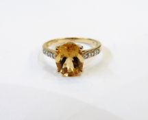 9ct gold, citrine and diamond ring, the citrine raised clasp with sloping shoulders,