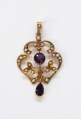 Edwardian 9ct gold, seedpearl and amethyst pendant of openwork scroll form,