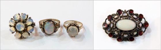 Moonstone set ring, a costume brooch set opals and garnets, a silver ring set opal doublet,