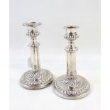 Pair of William IV silver candlesticks, the plain columns with beadwork borders,