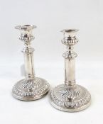 Pair of William IV silver candlesticks, the plain columns with beadwork borders,