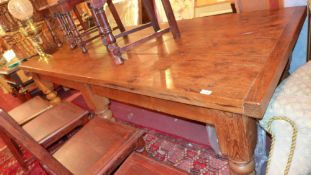 A large 19th century later pine farmhouse table the plank top raised on six heavy turned supports