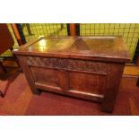 An 18th century carved oak coffer having rising lid