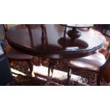 A 19th century rosewood breakfast table the circular top raised on scrolling triform supports