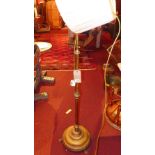 A Victorian brass standard lamp with shade