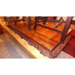 A 20th Century Chinese teak low table, the rectangular top over ornately pierced carved frieze and