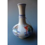 A Chinese porcelain famille rose vase decorated with seated figures, with six character marks to the