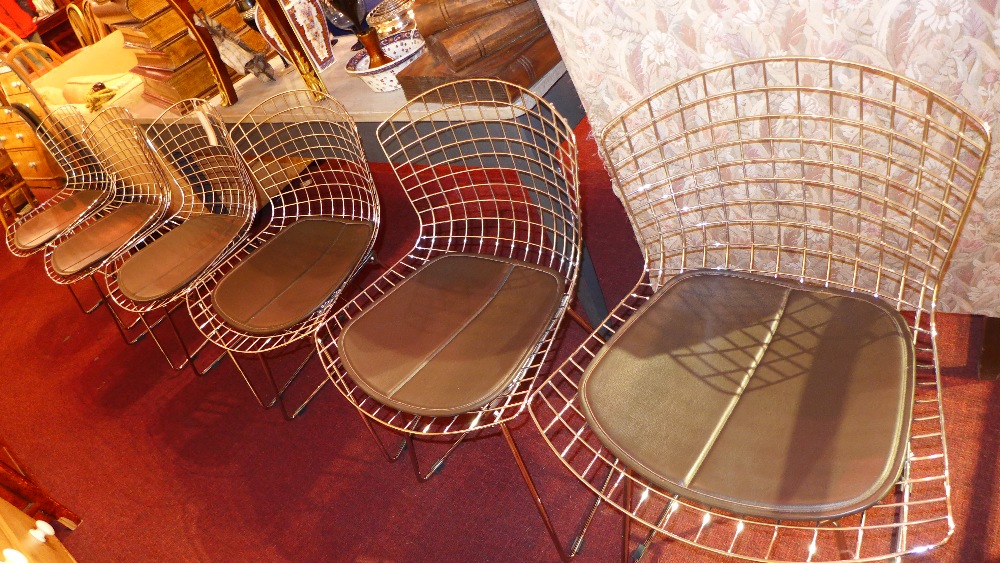 A set of six wirework Bertoia style dining chairs, chromed with brown leather seats