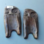 A pair of bronze owl form plaques