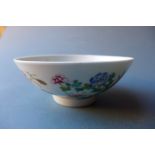 A Chinese porcelain bowl hand painted in the famille rose palette