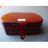 A tan leather jewellery box with fitted interior