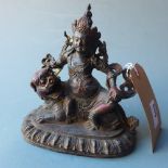 An Oriental bronze figure of a deity and a kylin