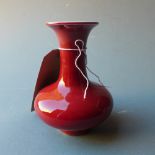 A Chinese porcelain vase with a red glaze