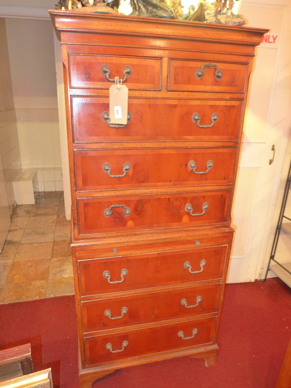 A Georgian style yew wood chest on chest fitted arrangement of drawers and brushing slide on bracket