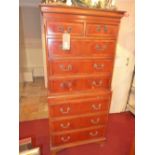 A Georgian style yew wood chest on chest fitted arrangement of drawers and brushing slide on bracket