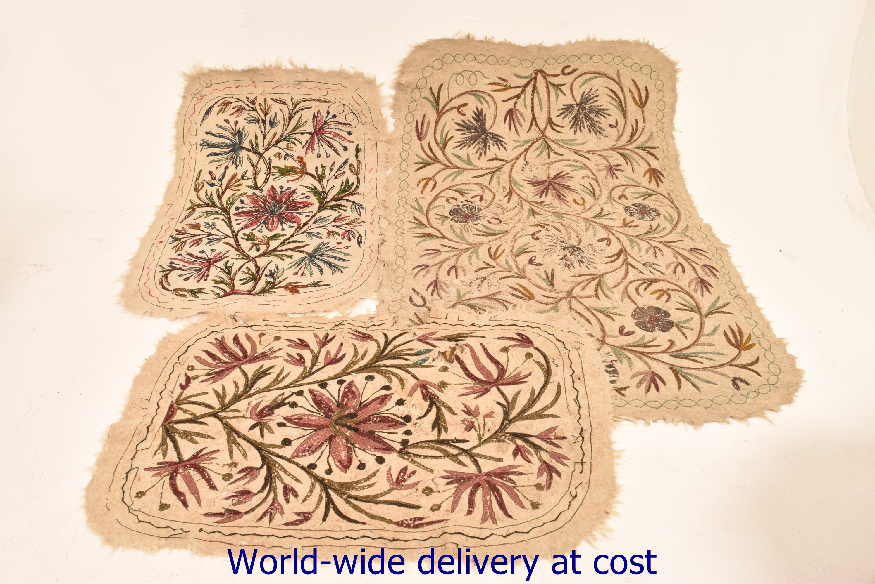 Three ivory coloured textiles with needl
