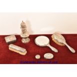 A William Comyns style hallmarked silver dressing table set having cherub detail in relief