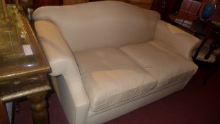 A David Seyfried camel back sofa upholstered in calico fabric raised on bun feet