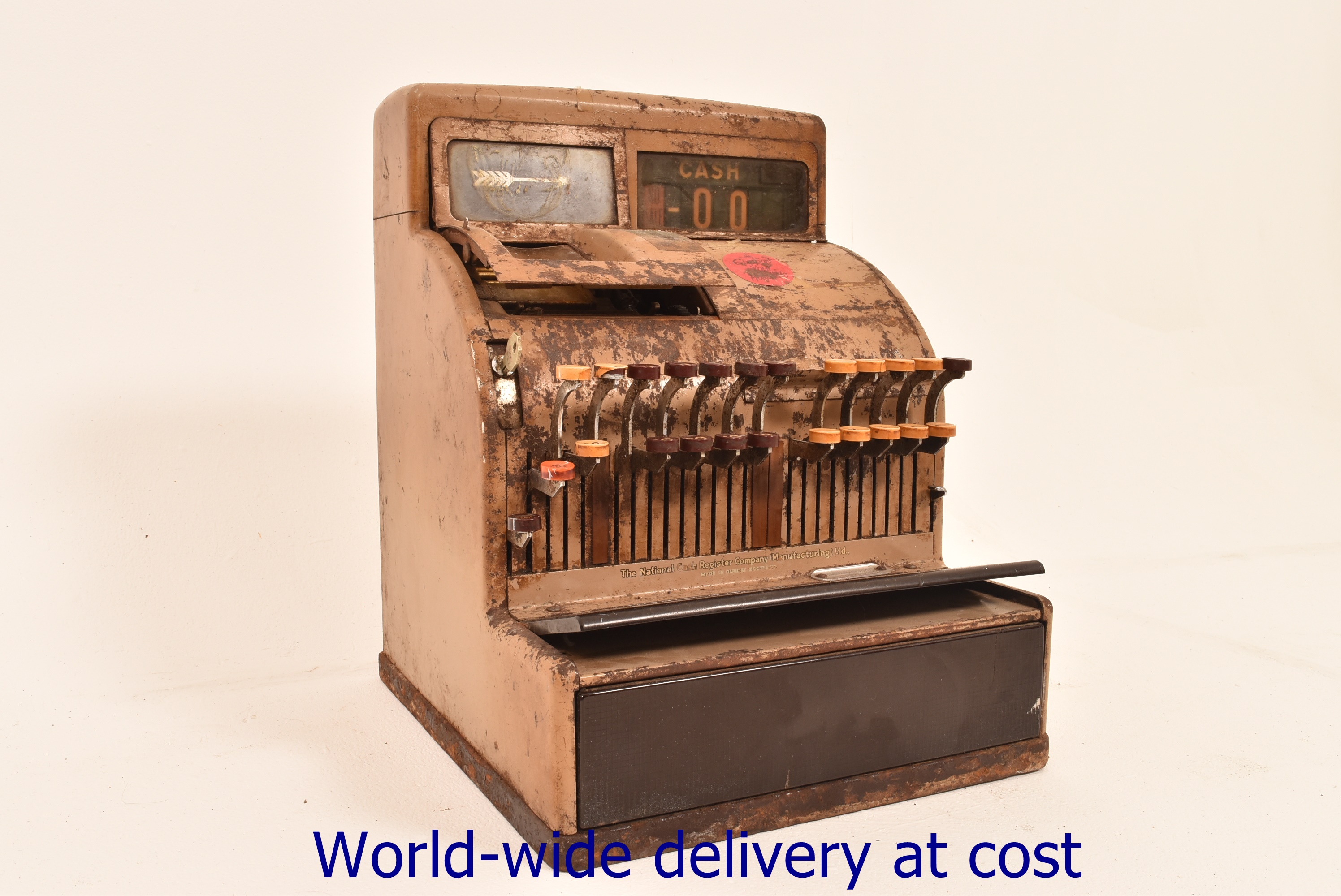 A vintage brown painted metal cash register