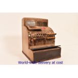 A vintage brown painted metal cash register