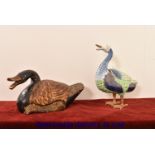 A porcelain model of a duck, heightened