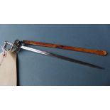 A hallmarked silver Asprey sword shaped letter opener with leather sheath