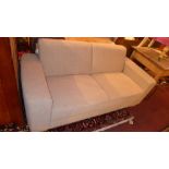 A contemporary designer John Lewis two seater sofa upholstered in beige mottled fabric and raised