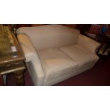 A David Seyfried camel back sofa upholstered in calico fabric raised on bun feet