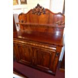 A Victorian carved flame mahogany chiffonier fitted frieze drawer and pair of panelled doors