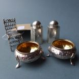 A pair of Victorian hallmarked silver salts having gilt interiors and repoussage decoration