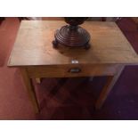 A pine kitchen table having single drawer raised on square section supports