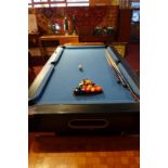 An Olimpo pool table with blue baize top,