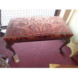 An early 20th century mahogany piano stool, with claw feet and shell motif to legs,