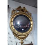 SOLD IN TIMED AUCTION A Regency giltwood wall mirror with convex plate,