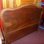 A French walnut double bed of a traditio