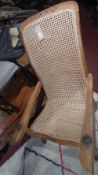 A caned teak planters chair