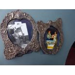 A pair of silver photo frames with putti