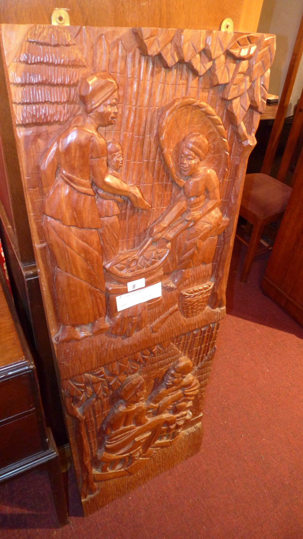 An African carved teak panel by E.O Yebo