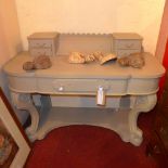 A grey painted and distressed 'Dutchess' dressing table raised on scrolling supports