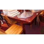 A mahogany extending dining table with folding leaf on tapered supports