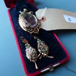 A cased Victorian mourning brooch together with the matching pair of earrings,