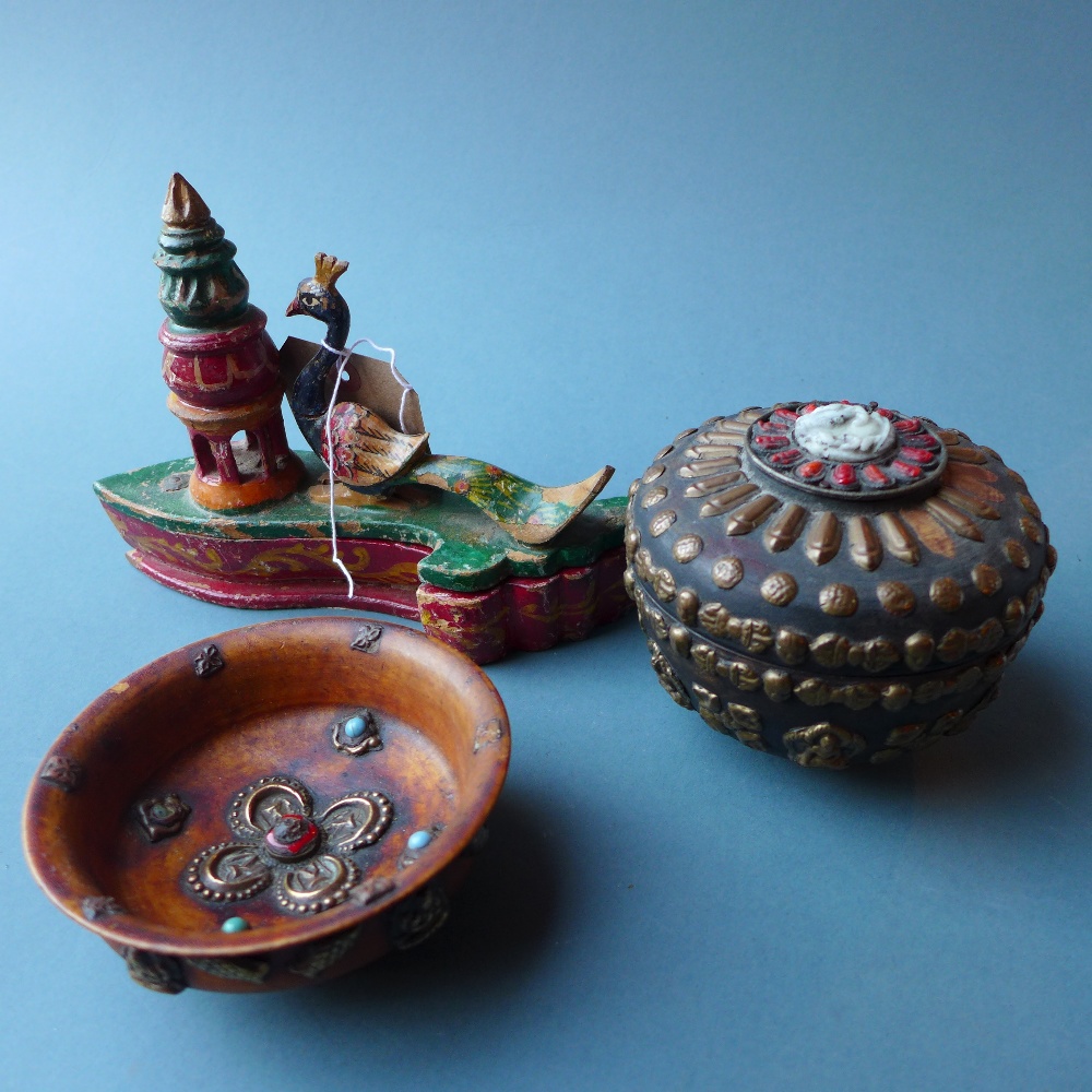 A Tibetan beetle nut bowl together with a similar jar and cover and an ornate carved and painted