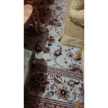 A large Persian style carpet with floral design on beige ground