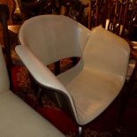 A pair of modernist armchairs leather an