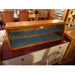 A 1960's teak tabletop cabinet with slid