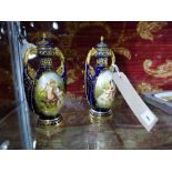 SOLD IN TIMED AUCTION A fine quality pair of Vienna porcelain urns, the hand painted panels signed,