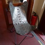 An industrial chair made from sheet meta