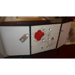 A 1950's black and white sideboard havin