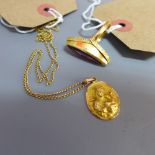 An 18ct gold and amethyst ring together with an oval pendant depicting Madonna and child,