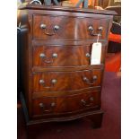 A mahogany serpentine fronted chest of four drawers and raised on carved bracket feet,